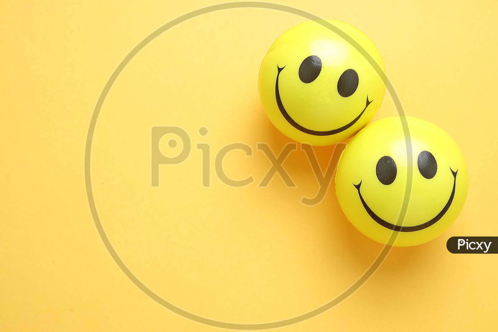Smile Yellow Balloon.Toy Balls On Yellow background. Smile Icons. Emoji. Emoticons .Top View Flat Lay Copy Space
