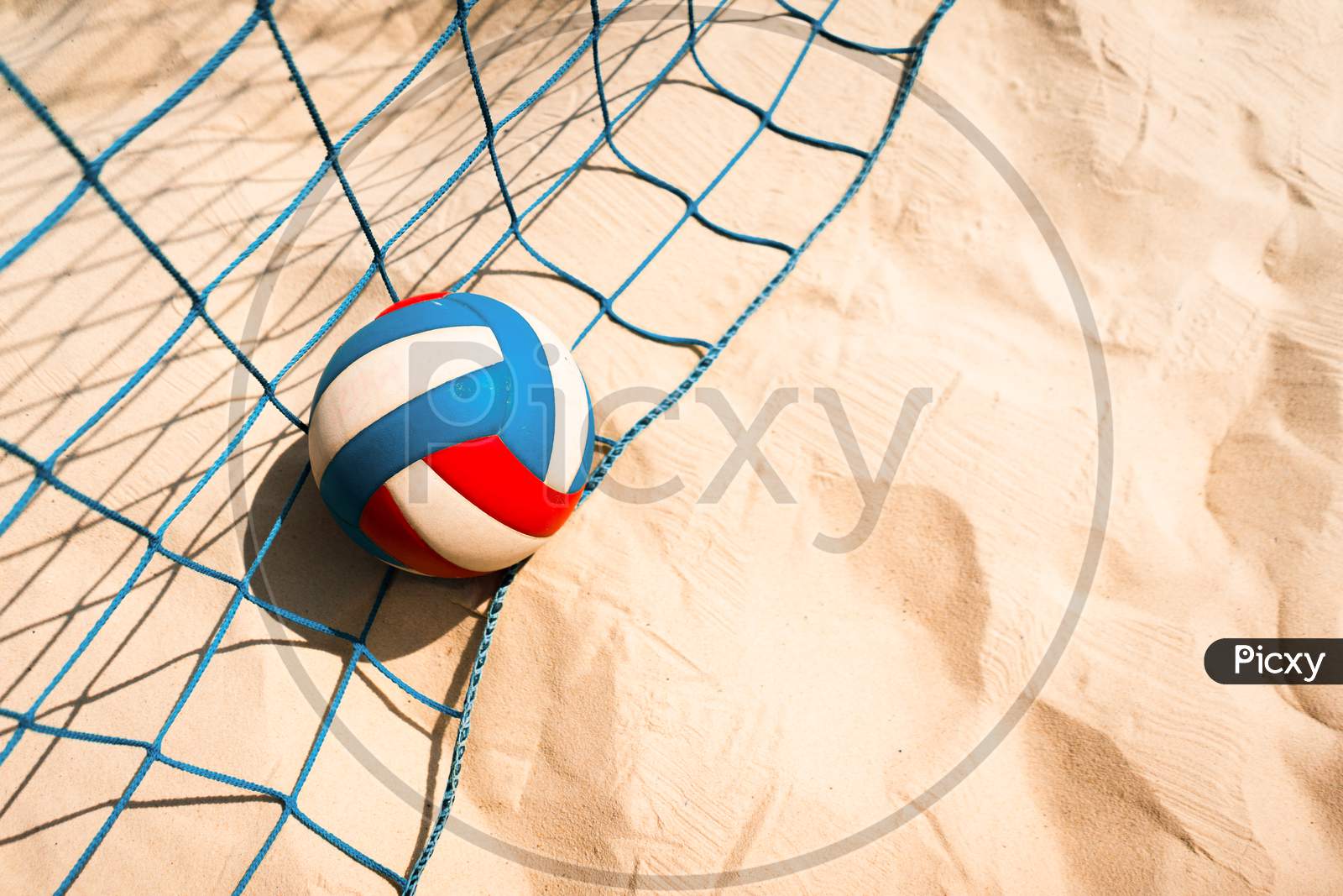 Volleyball and netting are on the beach