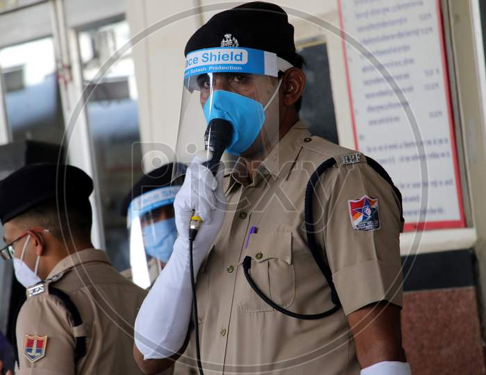 A security personnel stands near a special train which will be on-boarded by migrants to Bihar State from Ajmer railway station during a government-imposed nationwide lockdown as a preventive measure against the COVID-19 or coronavirus, in Ajmer on May 10, 2020.