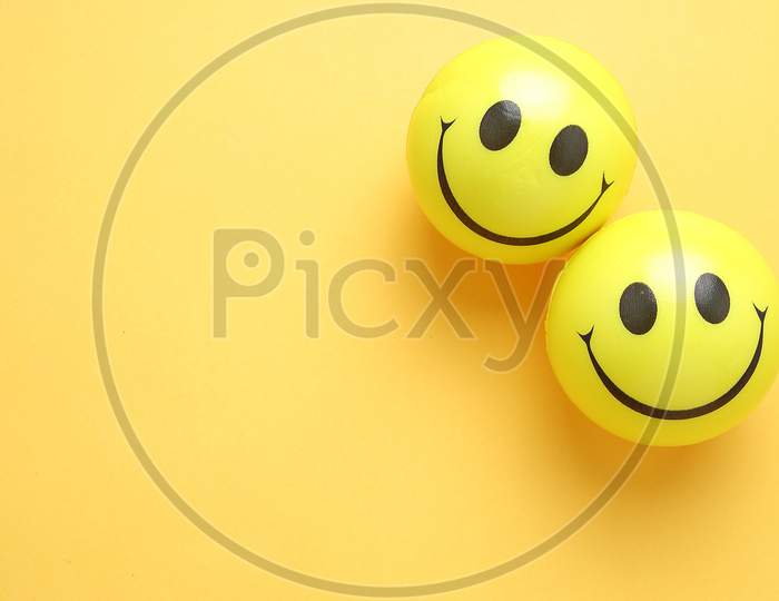 Smile Yellow Balloon.Toy Balls On Yellow background. Smile Icons. Emoji. Emoticons .Top View Flat Lay Copy Space