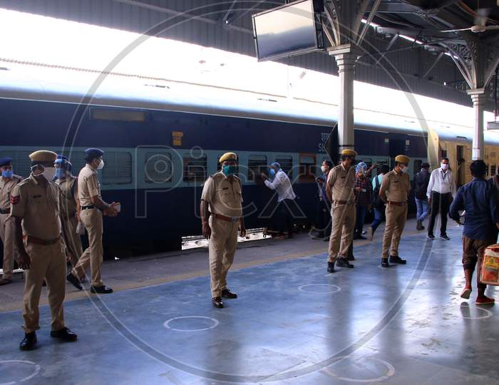 Security personnel stand near a special train which will be on-boarded by migrants to Bihar State from Ajmer railway station during a government-imposed nationwide lockdown as a preventive measure against the COVID-19 or coronavirus, in Ajmer on May 10, 2020.