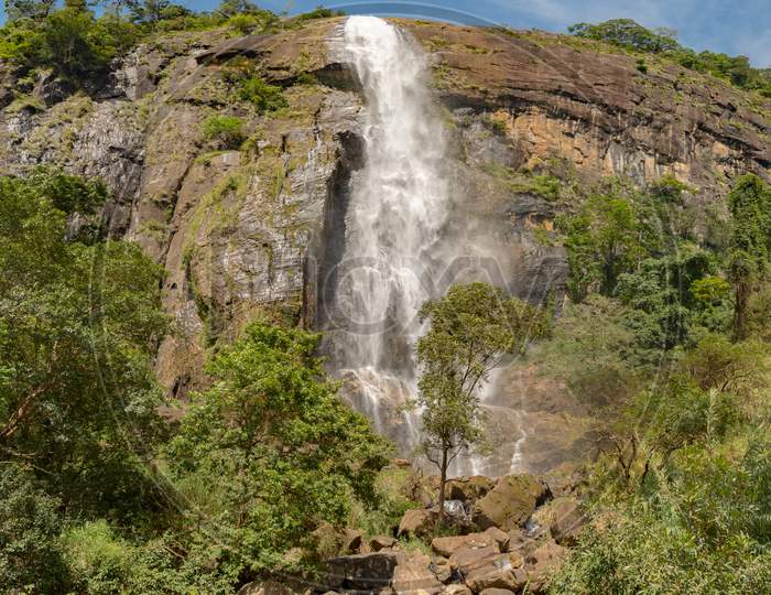 Sunny Day In The Tropical Waterfall Falls From The Mountain Cliff To The Jungle, Serene Landscape Of Diyaluma Falls.