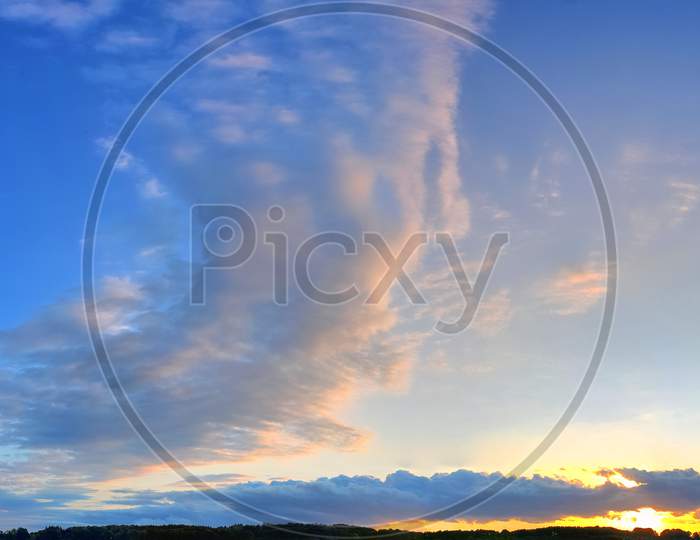 Beautiful red and orange cloud formations at sunrise in  a panorama sky view