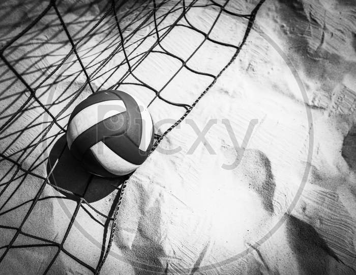 Volleyball and netting are on the beach Black and white view