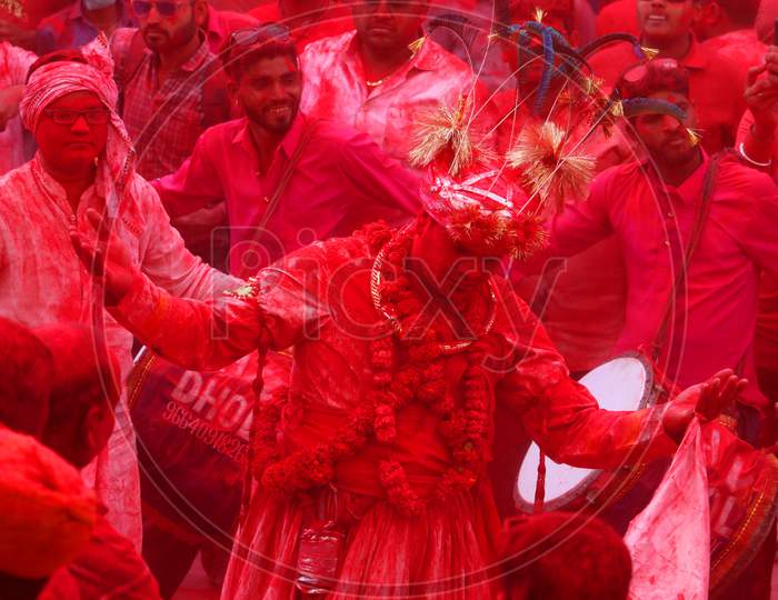 A man daubed in colour dances as he takes part in a colourful procession locally known as "Badshah ki Sawari" as part of Holi, the Festival of Colours, celebrations in Beawar, in the desert state of Rajasthan, India, 11 March 2020.