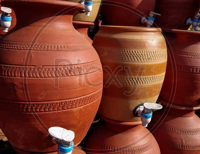 Pottery Plant With Many Ready Brown Pots Of Clay With Taps For Drinking Water.