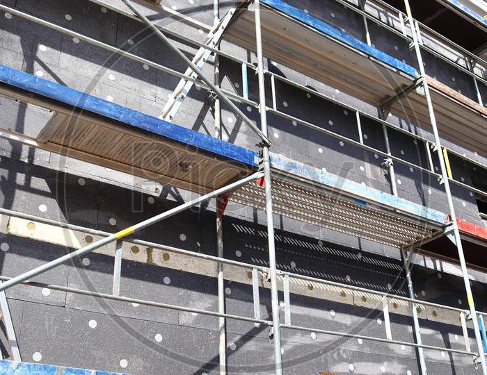 Scaffolding providing platforms for work in progress on a new apartment block
