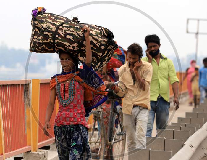 Migrant Workers Walking Along Highway Roads Carrying Belongings on Their Heads To reach Their Native Towns During Nationwide Lockdown Amidst Coronavirus Or COVID-19 Pandemic In Prayagraj, May 12, 2020.