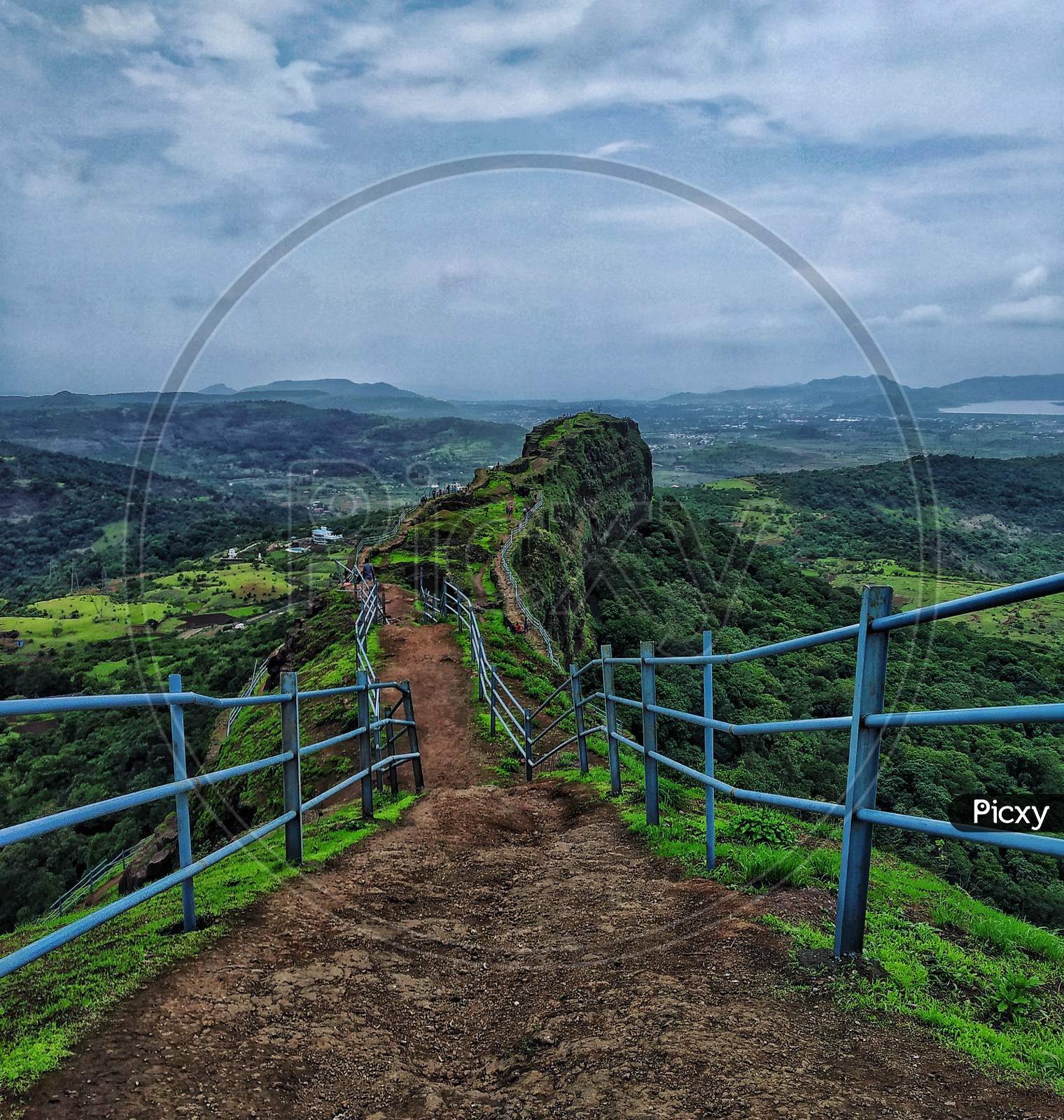 Lohagad , An Ancient Fort Near Pune In Mahahrashtra Having A Blue Railing. A Blue Sky And A Combination Of Some Clouds Creates A Good Landscape Photography Scene.