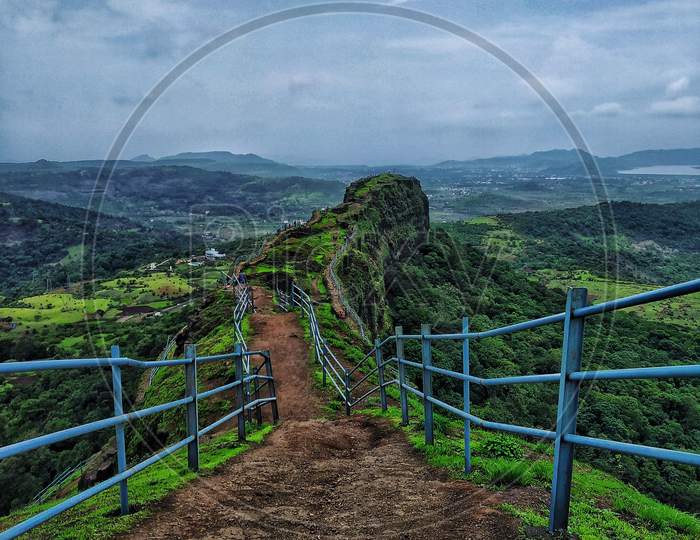 Lohagad , An Ancient Fort Near Pune In Mahahrashtra Having A Blue Railing. A Blue Sky And A Combination Of Some Clouds Creates A Good Landscape Photography Scene.