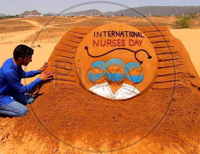 Indian Artist creates sand art on the occasion of International nurses day in Pushkar, Rajasthan on 12 may 2020.