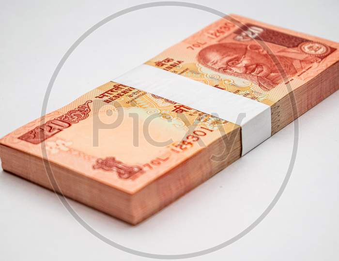 Bundle of indian currency notes of twenty rupees on white background