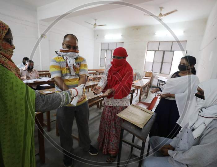 Teachers Sanitise Their Hands Before Marking Uttar Pradesh Board Copies During Nationwide Lockdown Amidst Coronavirus Or COVID-19 Pandemic  In Prayagraj, May 12, 2020