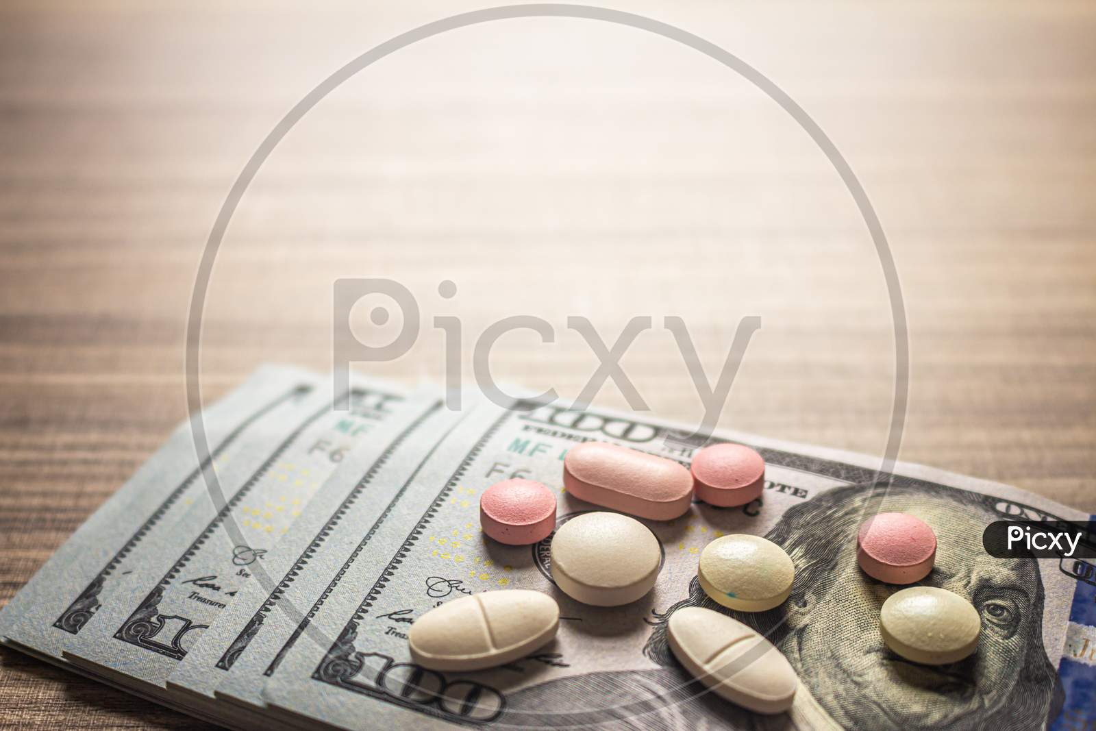 Concept Of Cost Of Medicines. Pills On A Brown Table With Bills.