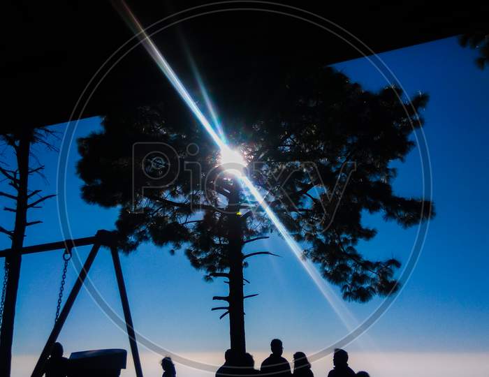 People standing at sunset point of Kasauli hills in himachal pradesh under clear sunlight landscape