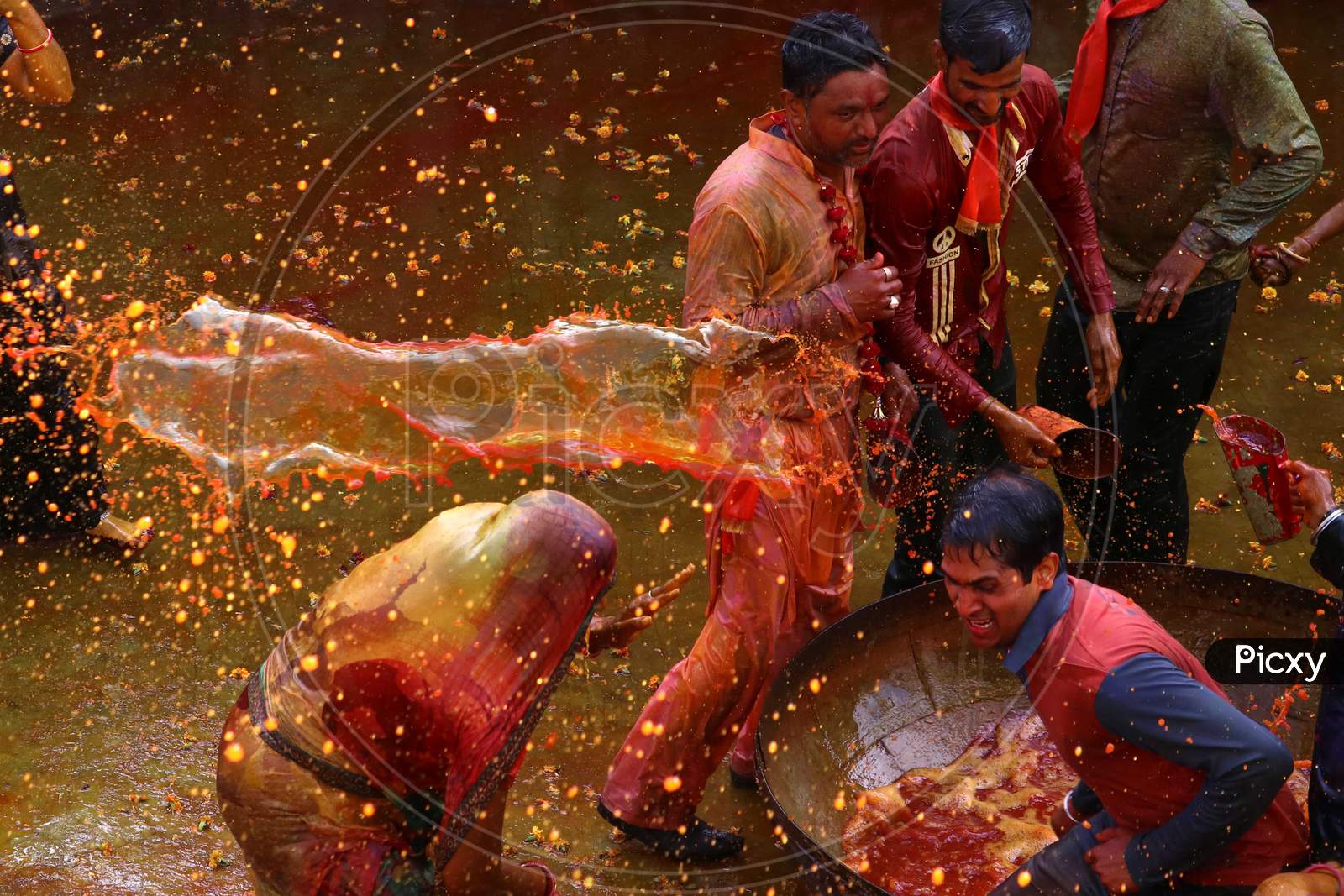 Men throw coloured water on women as they try to beat them with ropes made from cloth during "Kodamar" Holi as part of Holi, the Festival of Colours, celebrations in Beawar, Rajasthan, India on 11 March 2020.