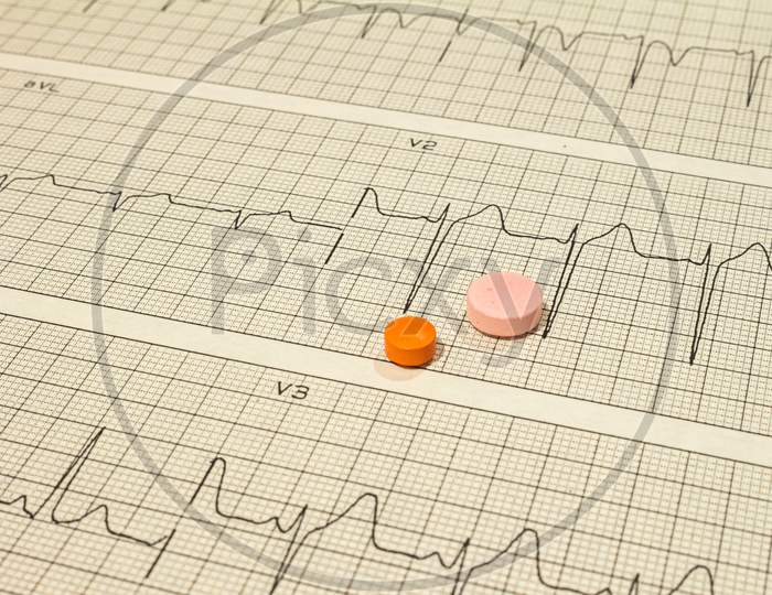 Some Pills On Electrocardiograms. Records Of Cardiac Activity. Drugs In Tablet Forms. Concept Of Cardiovascular Disease.