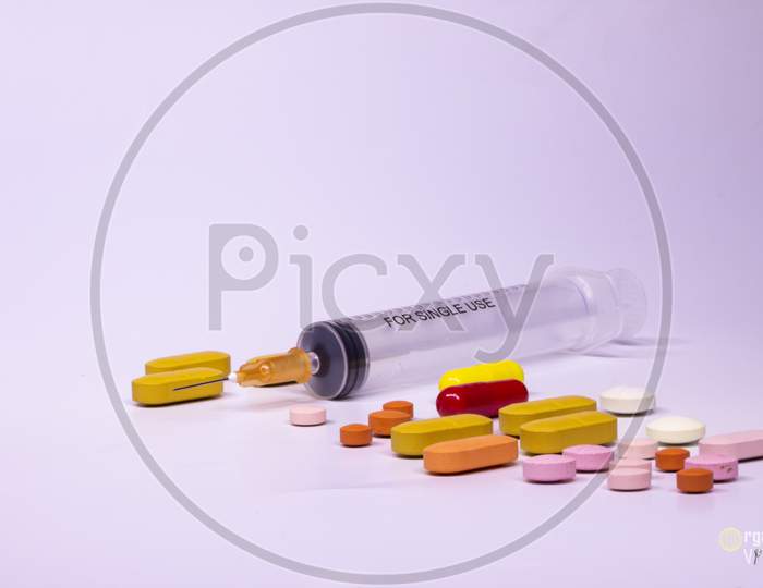 Colored Pills On White Background Medicines For Use In Humans. Drugs For Legal Use. Pharmaceutical Industry. Free Space To Write.
