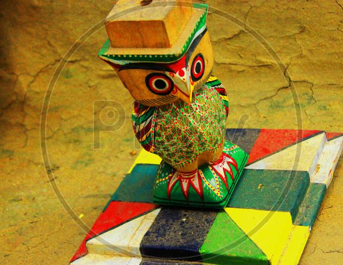 A solo wooden owl standing