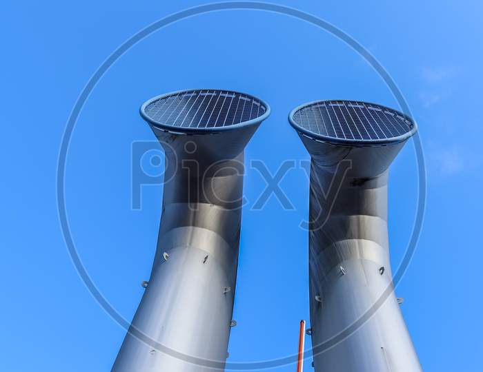 Industrial pipes made of steel in front of a blue sky