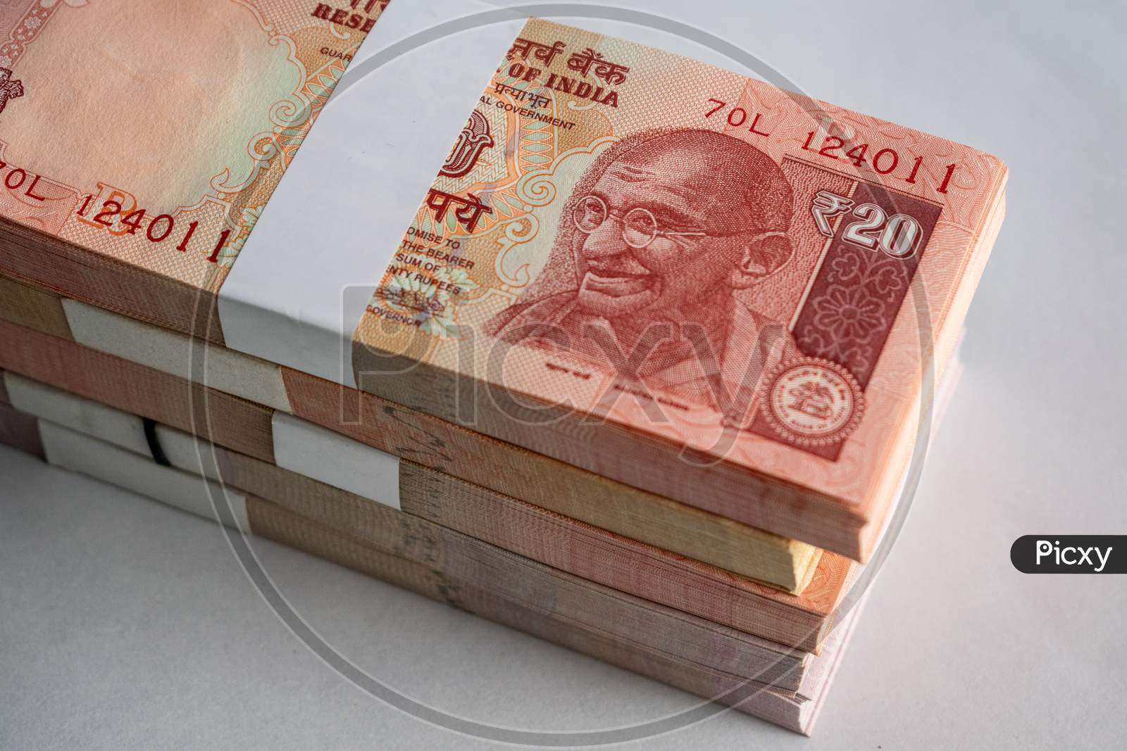 Indian currency banknotes placed over a white background