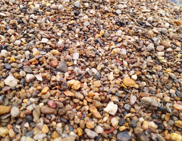 Small river stones or pebbles of various colors. colorful gravel background