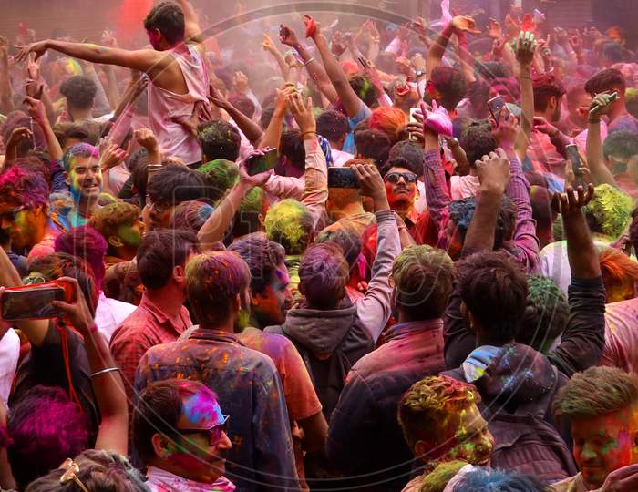 Foreign tourist smeared in colour powder celebrates the Holi, the spring festival of colours in pushkar, Rajasthan, India on 10 March 2020.