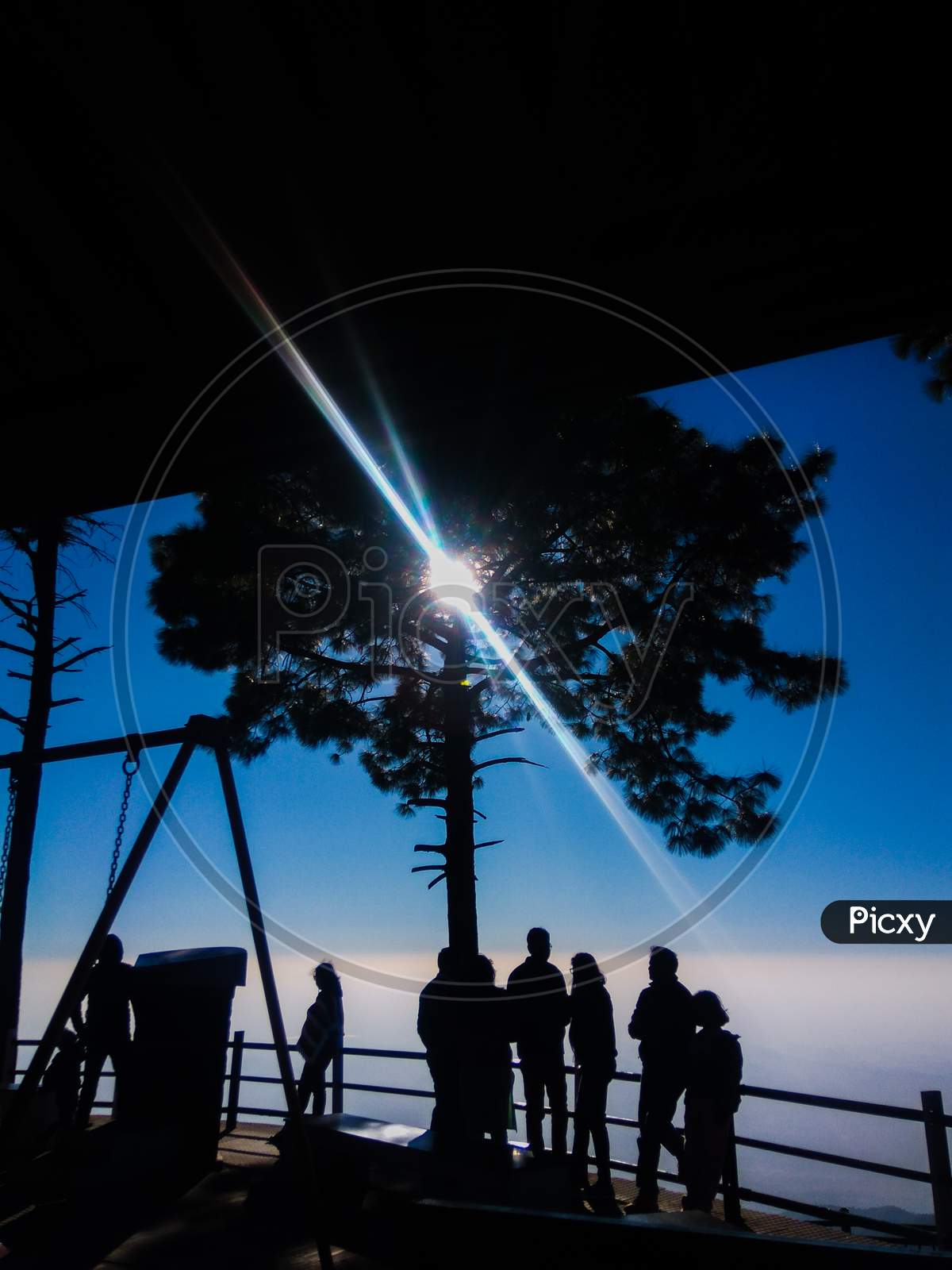 People standing at sunset point of Kasauli hills in himachal pradesh under clear sunlight landscape