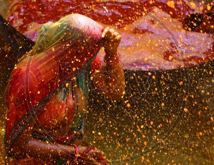 Men throw coloured water on women as they try to beat them with ropes made from cloth during "Kodamar" Holi as part of Holi, the Festival of Colours, celebrations in Beawar, Rajasthan, India on 11 March 2020.