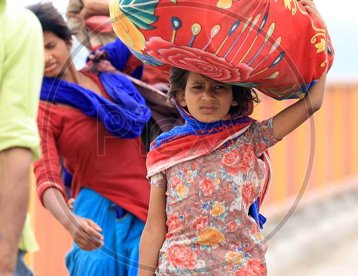 Migrant Workers Walking Along Highway Roads Carrying Belongings on Their Heads To reach Their Native Towns During Nationwide Lockdown Amidst Coronavirus Or COVID-19 Pandemic In Prayagraj, May 12, 2020.
