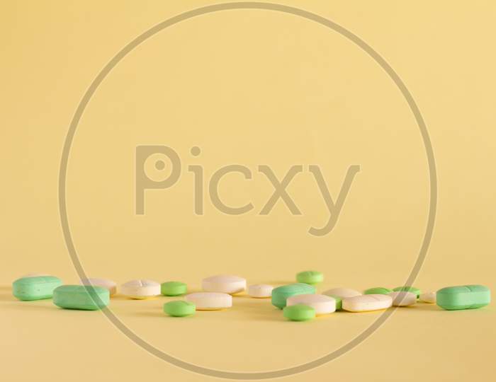 Medicines On A Neutral Yellow Background. Drugs For Legal Use. Pharmaceutical Industry. Concept Of Medication Abuse. Medicines For Medicinal Use. Copy Space