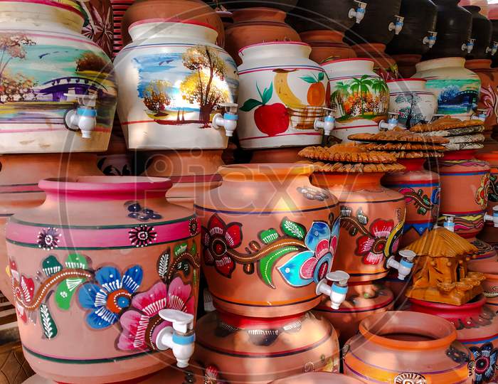 Decorated Colored Pots Of Clay With Taps For Drinking Water.
