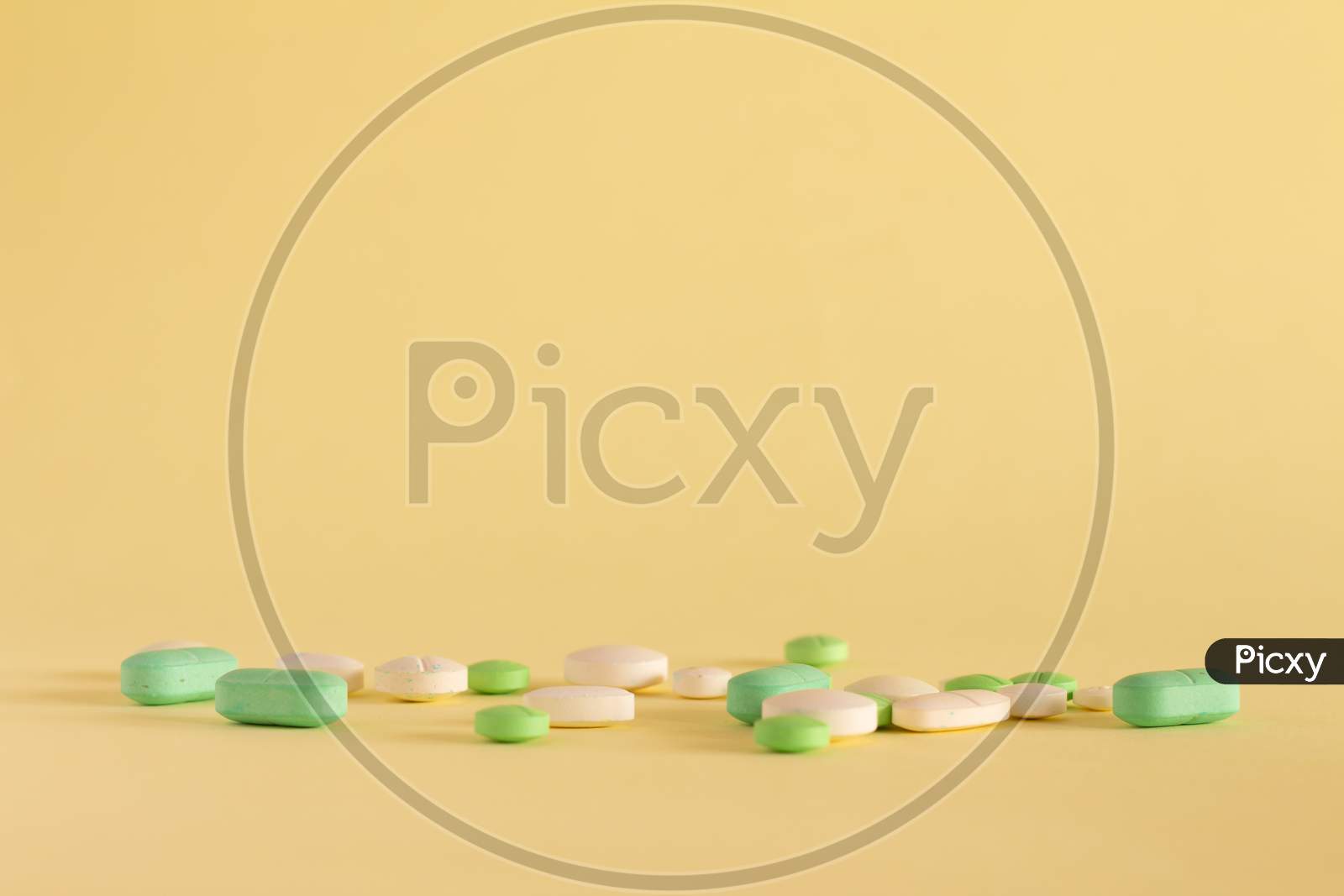 Medicines On A Neutral Yellow Background. Drugs For Legal Use. Pharmaceutical Industry. Concept Of Medication Abuse. Medicines For Medicinal Use. Copy Space