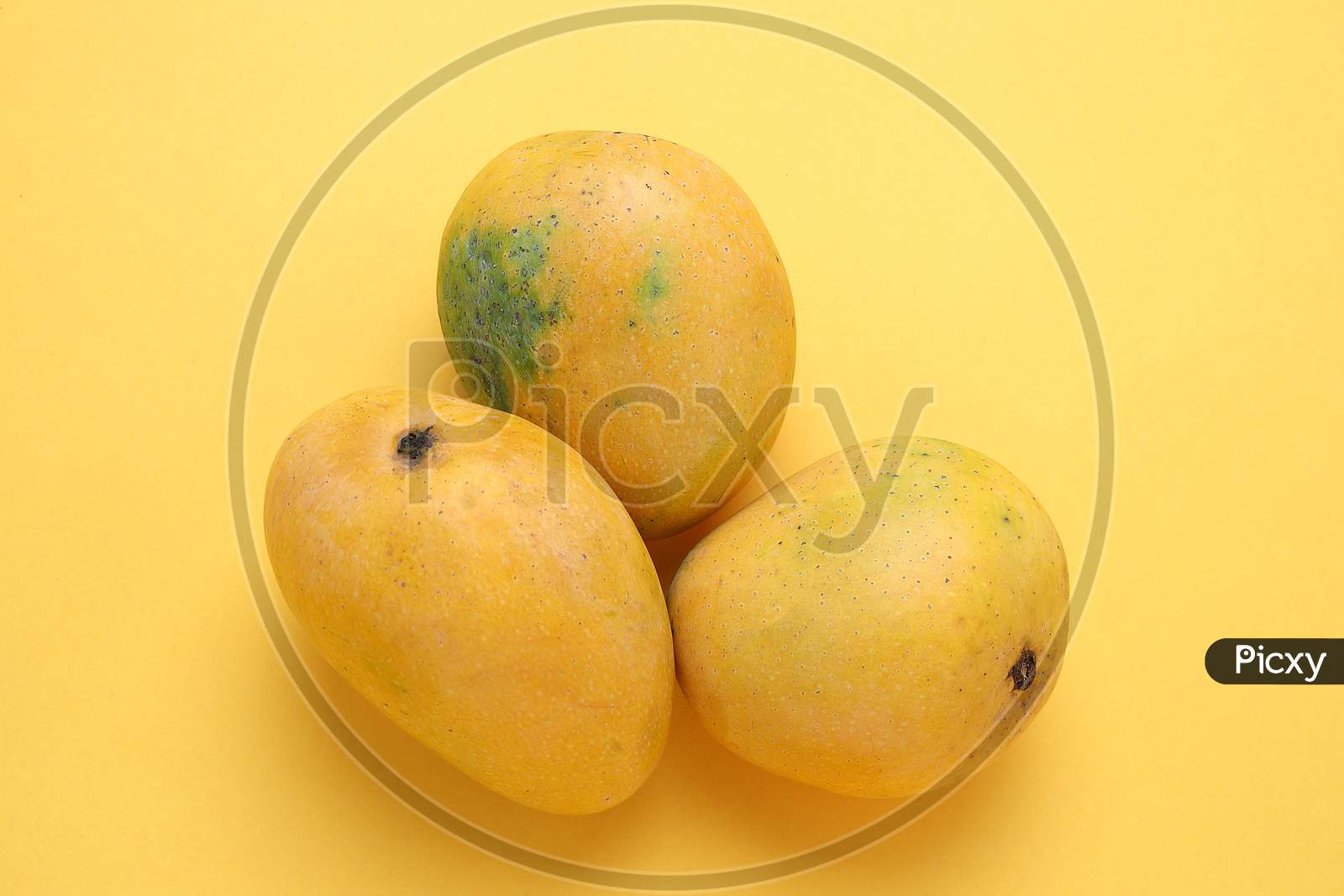 Yellow Mango Isolated On Yellow Background,Copy space for the ads