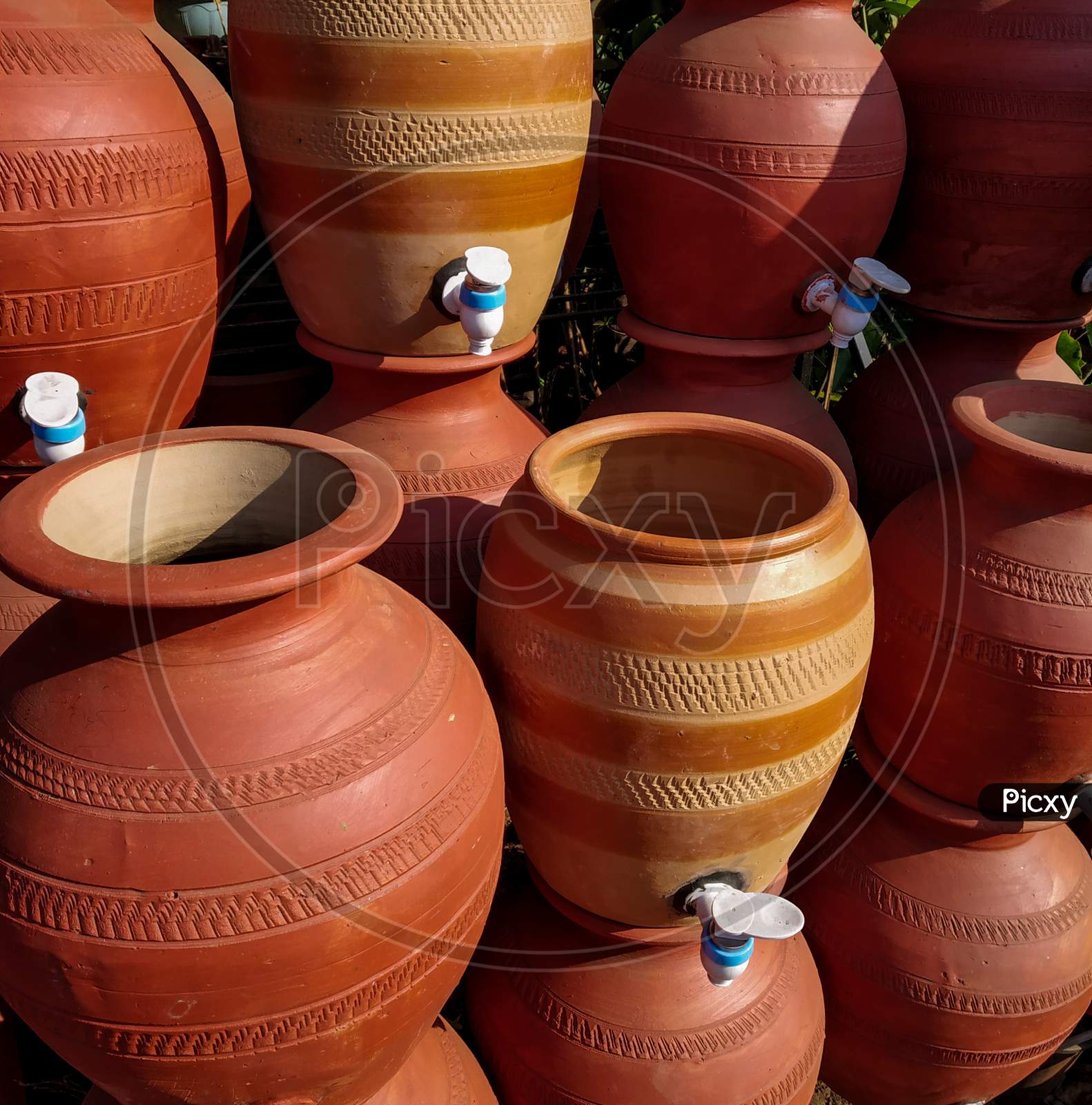 Pottery Plant With Many Ready Brown Pots Of Clay With Taps For Drinking Water.