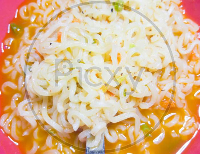 Famous Home Made Asian Instant Noodle In A Porcelain Bowl With Fork And Spoon Close Up.