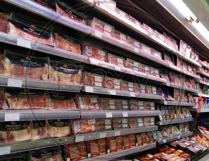 Meat, Supermarket, Butcher. Packets Of Meat At The Supermarket. Meat Aisle In Supermarket. Packaged Meats In Supermarket Refrigerated Section. Bacon, Turkey, Chicken, Steak.