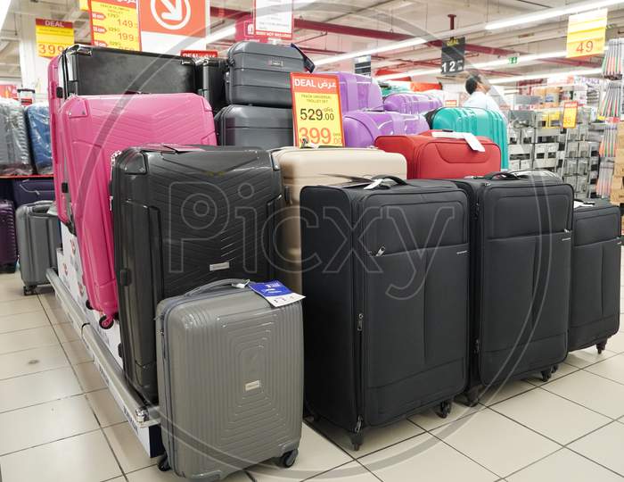 Department Store Interior View With Luggage Zone. Multicolored Suitcases In Store For Sale. Plastic And Cloth Suitcases With Discount Tags. Concept Of Black Friday Discounts.