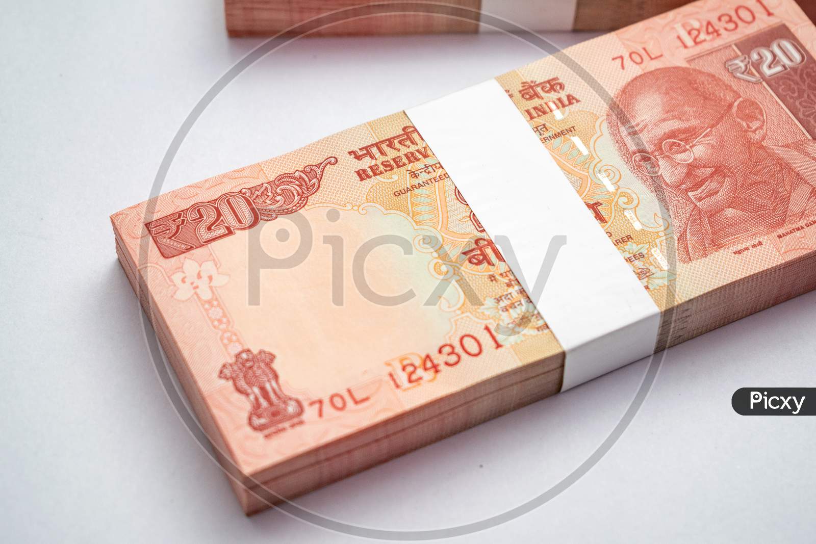 Bundles of Indian currency notes of 20 rupees isolated on white background