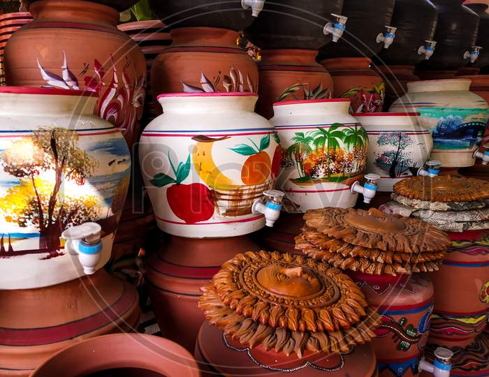 Decorated Colored Pots Of Clay With Taps For Drinking Water.