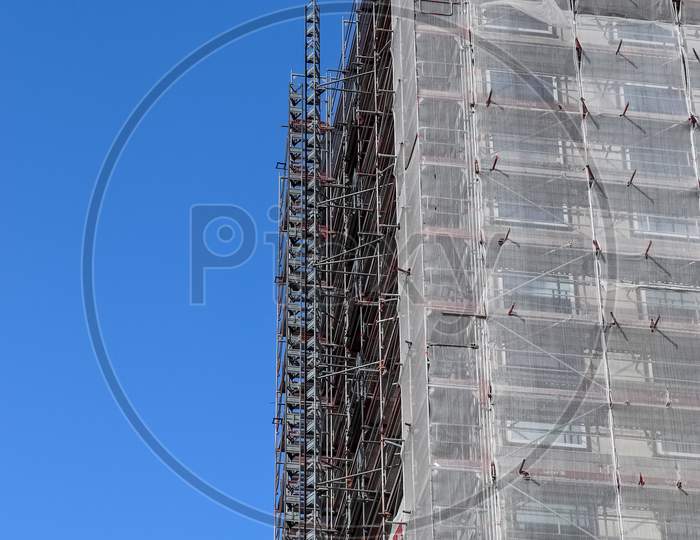 Scaffolding providing platforms for work in progress on a new apartment block