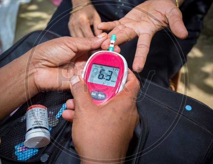 Doctor Checking Patient For Diabetes or Blood Sugar With a Glucose meter Closeup