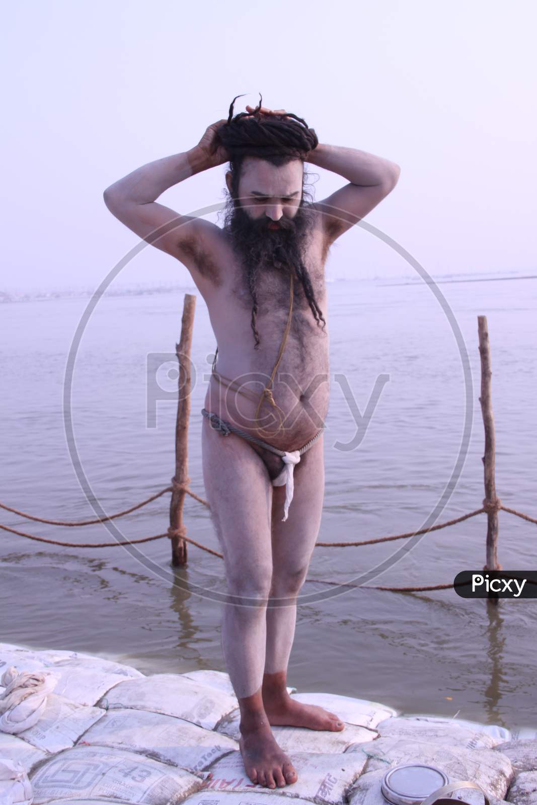 Image of A Naga sadhu or a Hindu holy man stands during the 