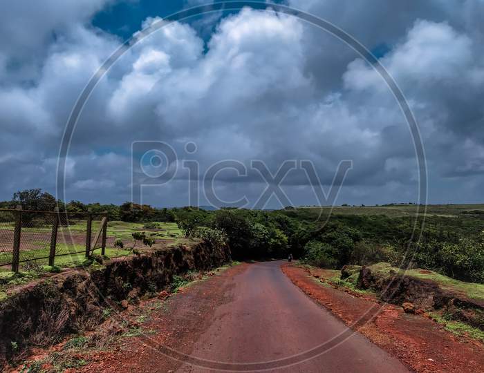 Landscape Of Road With A Blue Sky And White Clouds