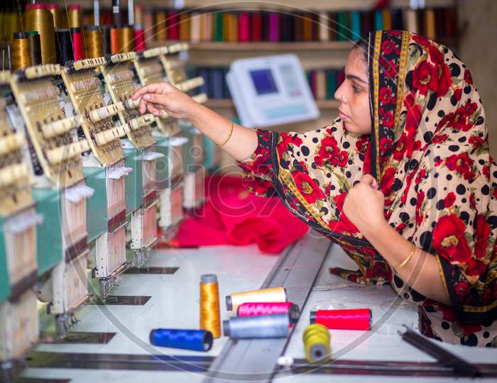 Bangladesh – August 6, 2019: A Bangladeshi Woman Garments Worker Working With Computerized Embroidery Machine At Madhabdi, Narsingdi, Bangladesh.