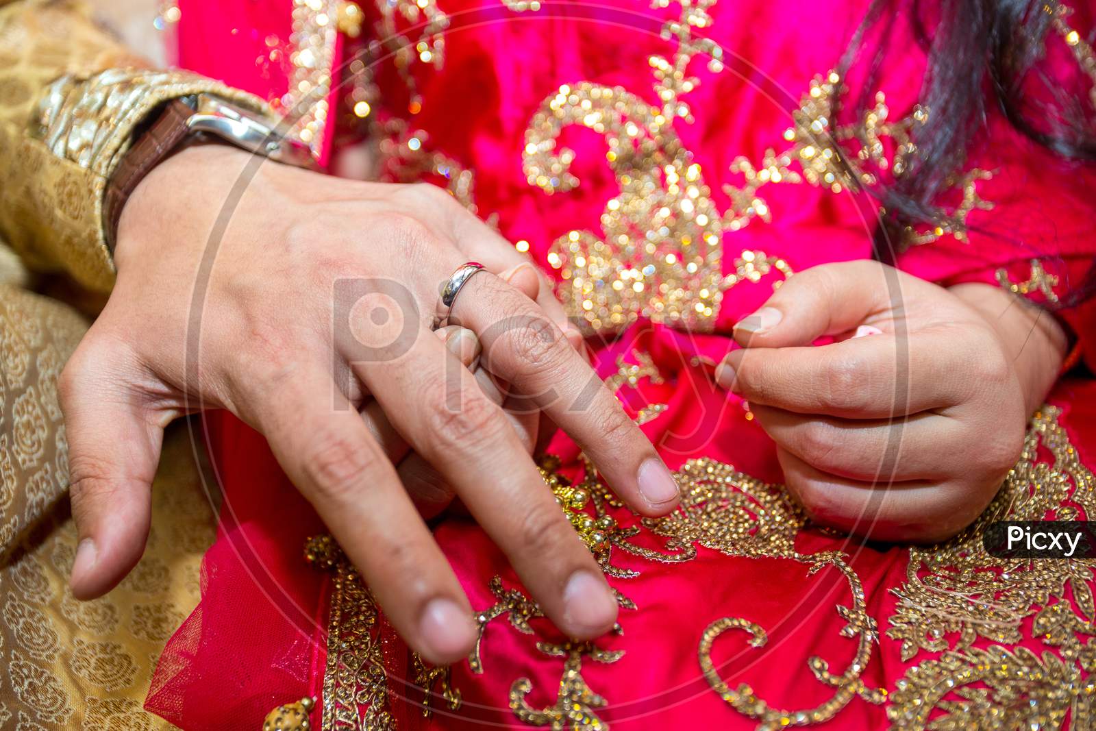 image-of-groom-places-the-wedding-ring-on-the-bride-s-finger-at