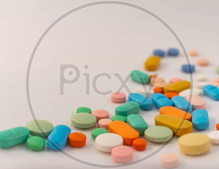 Drugs In The Form Of Medicines. Capsules And Tablets Of Various Colors And Shapes For Human Use. Pharmaceuticals On White Background.