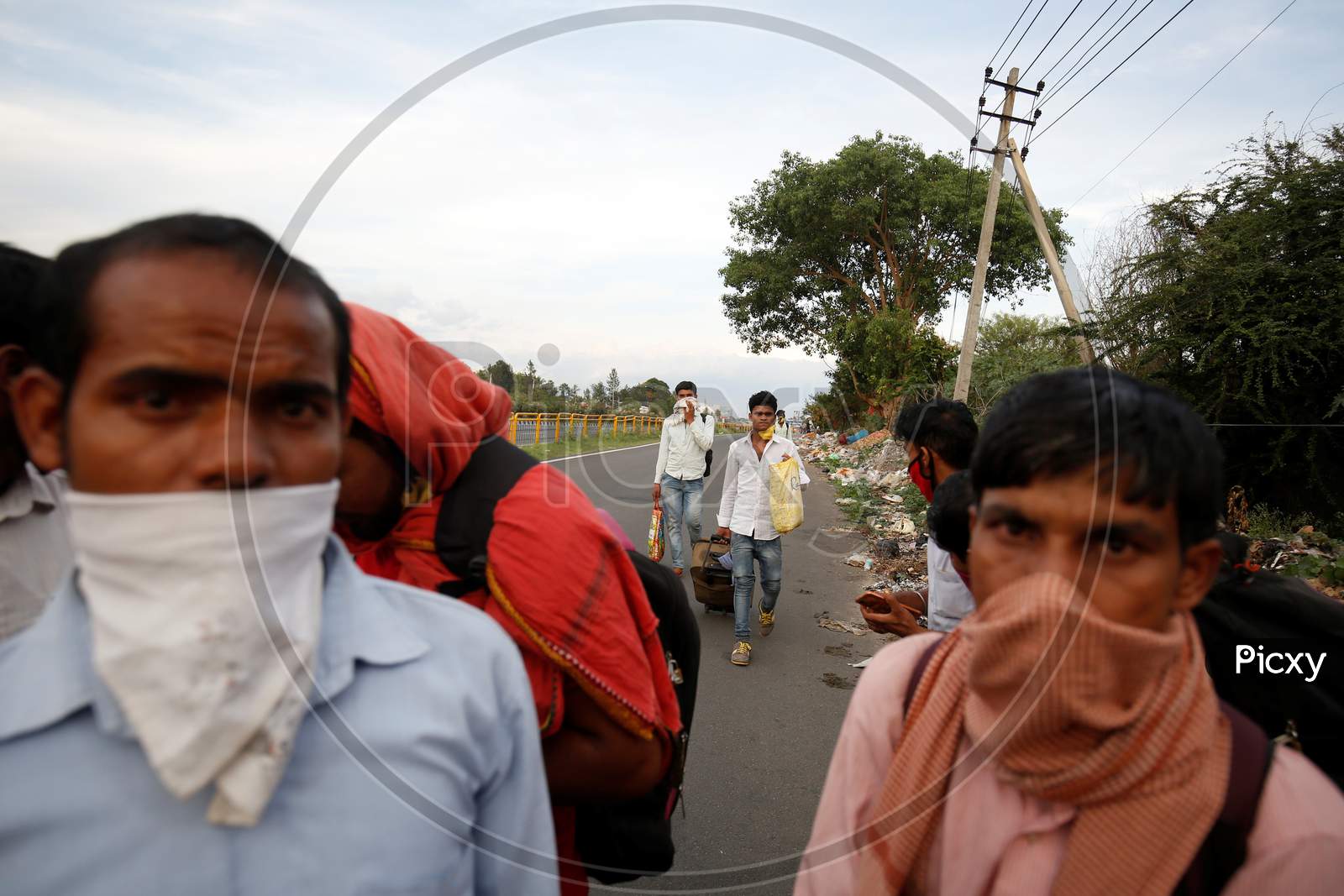 Migrant workers walking to the northern state of Bihar stop to show their papers at a police check post during the nationwide lockdown to stop the spread of coronavirus (Covid-19) in Bangalore, India.