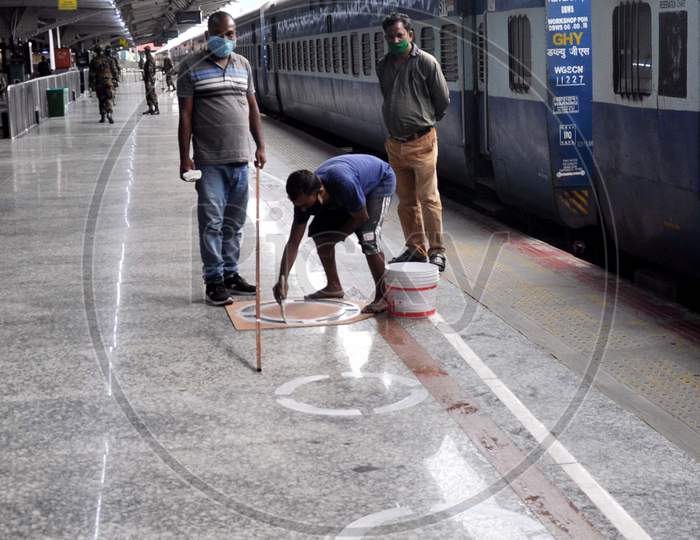 An Employee Marking Circles On A Railway Platform To Maintain Social Distance At Guwahati Railway Station During Nationwide Lockdown Amidst Coronavirus Or Covid- 19 Pandemic, In Guwahati On May 13, 2020.
