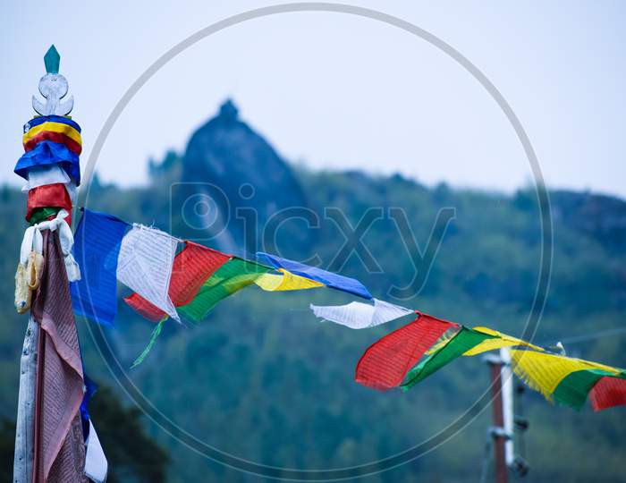Colourful buddhist tibetan prayer flags waving in the wind over the sky at India